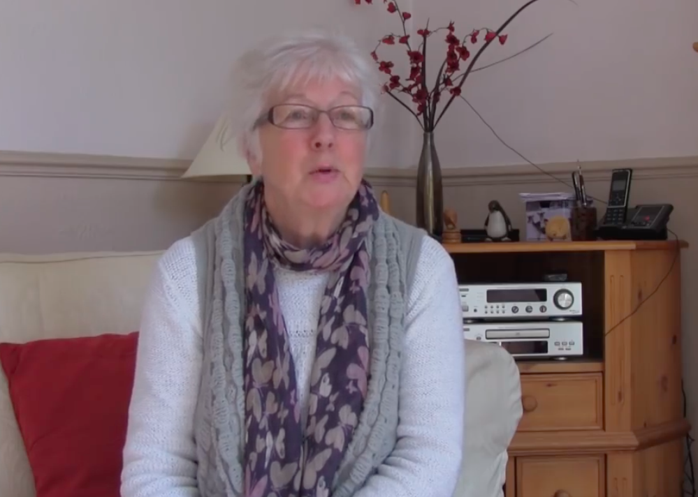 A woman victimized by a romance scammer