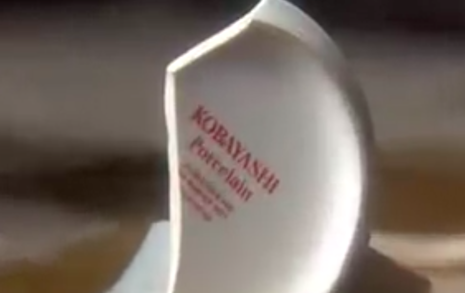 Broken coffee mug with clue to scam