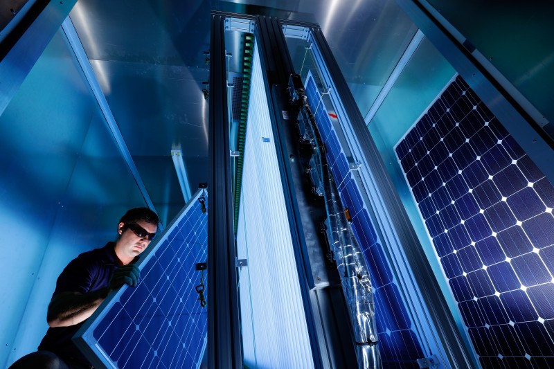 A testing company works with solar panels while testing the cybersecurity of solar inverters.
